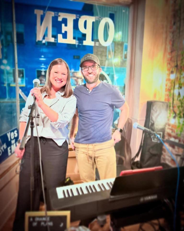 Devin Frank and Kendra German standing beside microphones and a keyboard at a Northwest Ohio venue